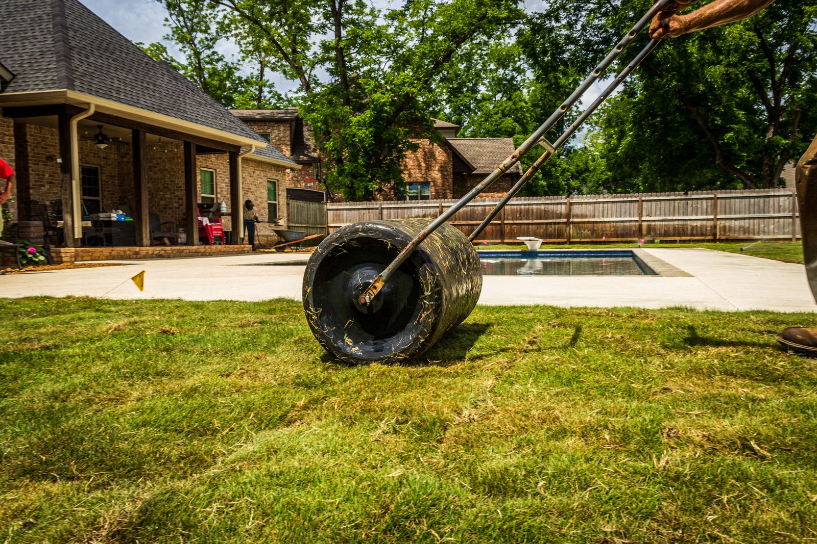 Landscaper laying turf in a backyard
