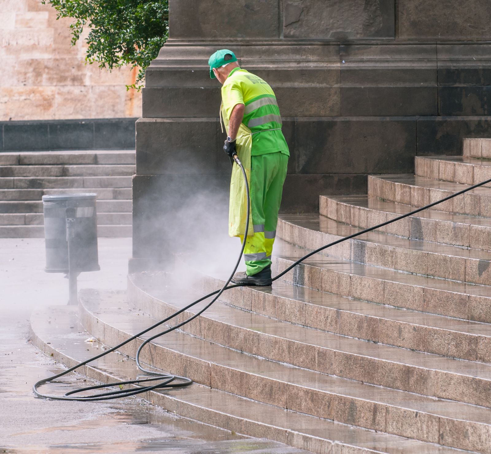 Pressure washing a house exterior wall